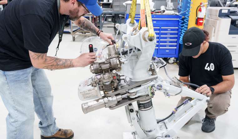 Technicians working on landing gear